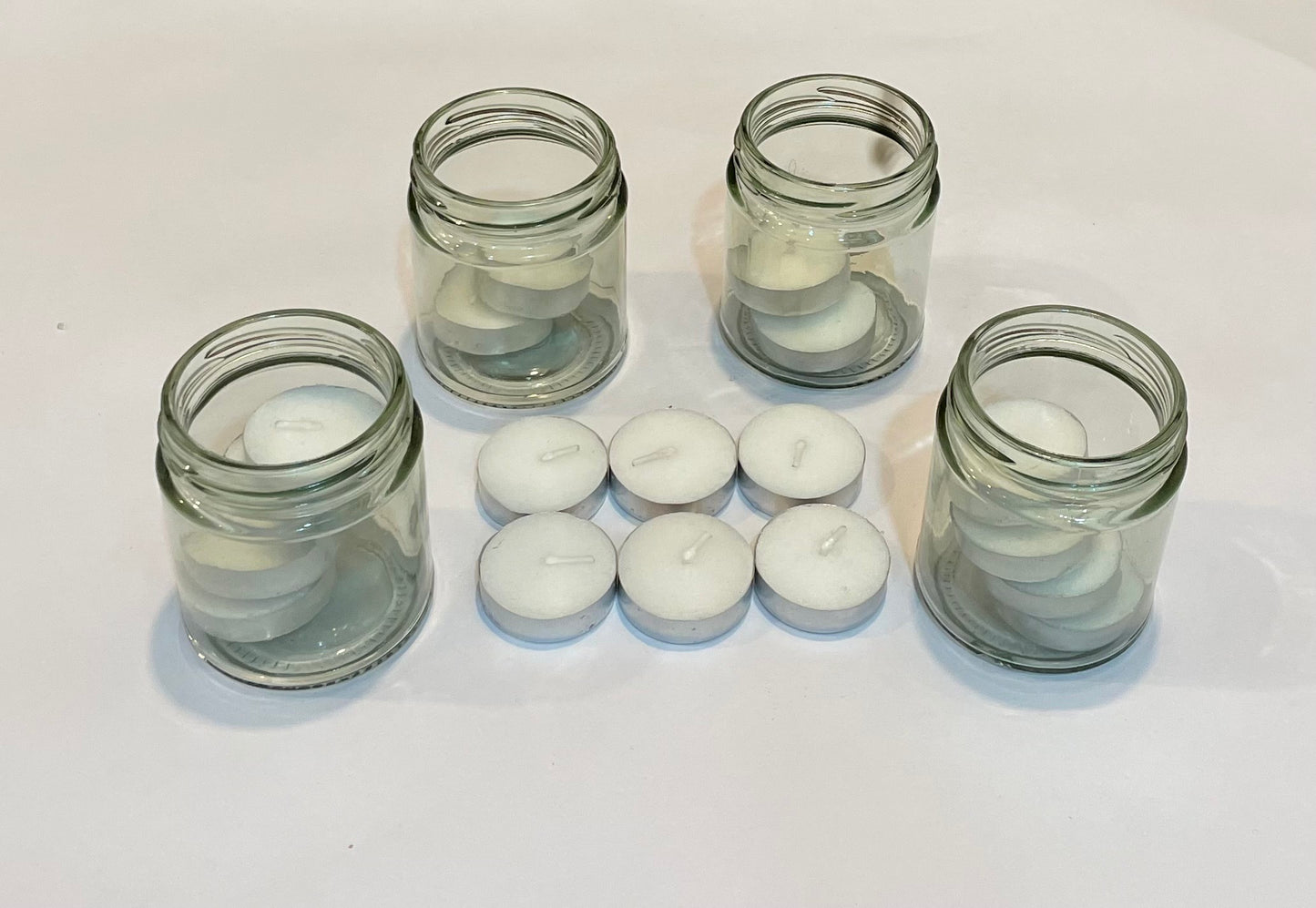 16 tea-lights along with 4 multipurpose glass Jars